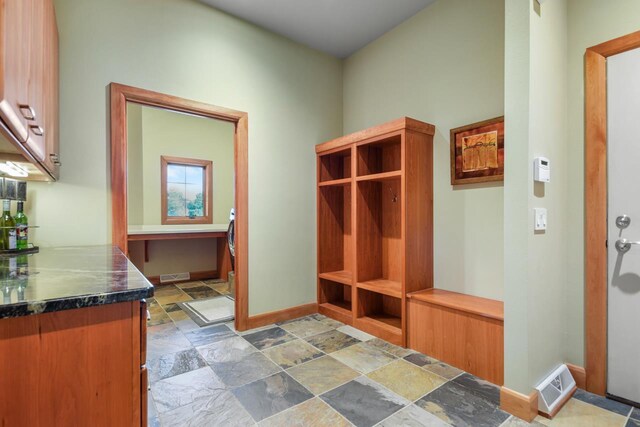 7548 Fallen Oak Dr, Verona, WI 53593 - mudroom featuring stone tile floors, baseboards, and visible vents