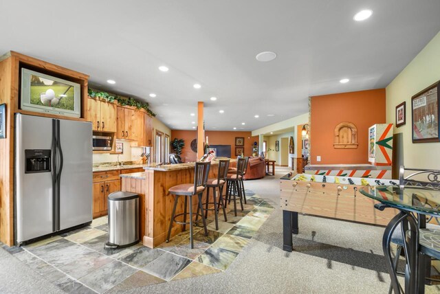7548 Fallen Oak Dr, Verona, WI 53593 - kitchen with light countertops, recessed lighting, appliances with stainless steel finishes, an island with sink, and a breakfast bar area