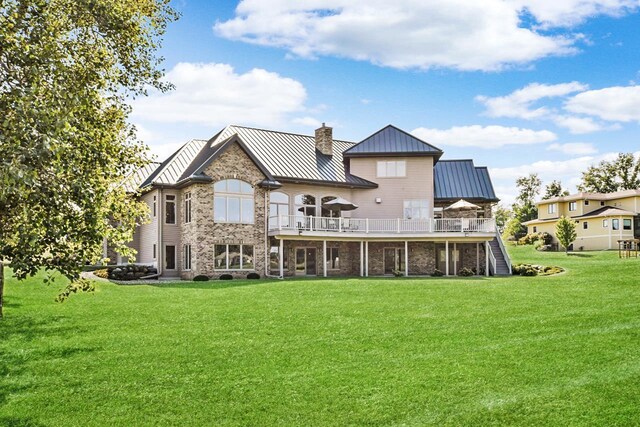 7548 Fallen Oak Dr, Verona, WI 53593 - back of property with a standing seam roof, stairway, metal roof, stone siding, and a lawn