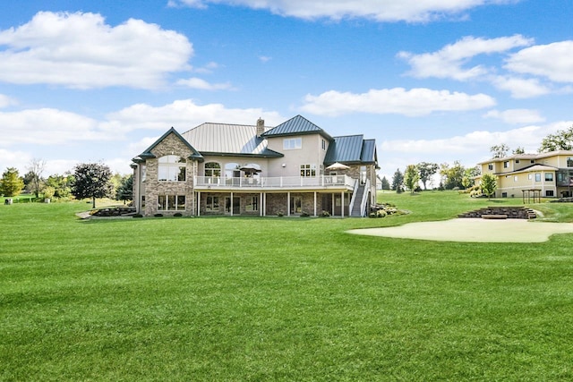 7548 Fallen Oak Dr, Verona, WI 53593 - rear view of property featuring metal roof, stone siding, a standing seam roof, and a yard