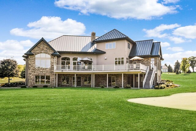7548 Fallen Oak Dr, Verona, WI 53593 - back of property with a lawn, a standing seam roof, stairs, and metal roof