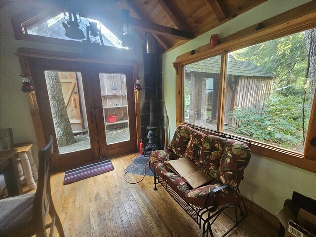 W16099 Manglos Ave, Sheldon, WI 54766 - sunroom / solarium with hardwood / wood-style floors, vaulted ceiling with beams, and a wood stove