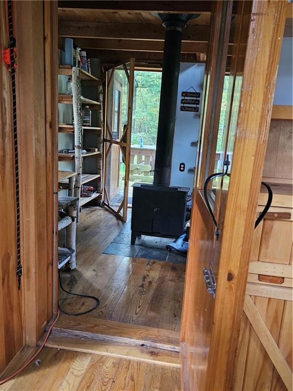 W16099 Manglos Ave, Sheldon, WI 54766 - interior space featuring hardwood / wood-style floors and a wood stove