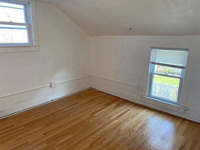 bonus room with vaulted ceiling and wood finished floors