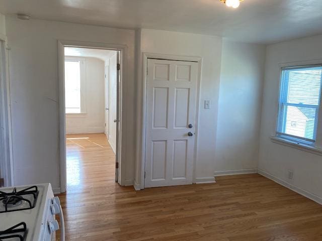 foyer featuring light wood-style flooring and baseboards