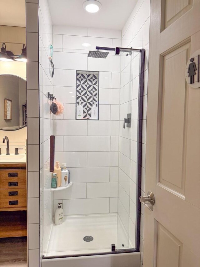 full bathroom featuring a stall shower and vanity