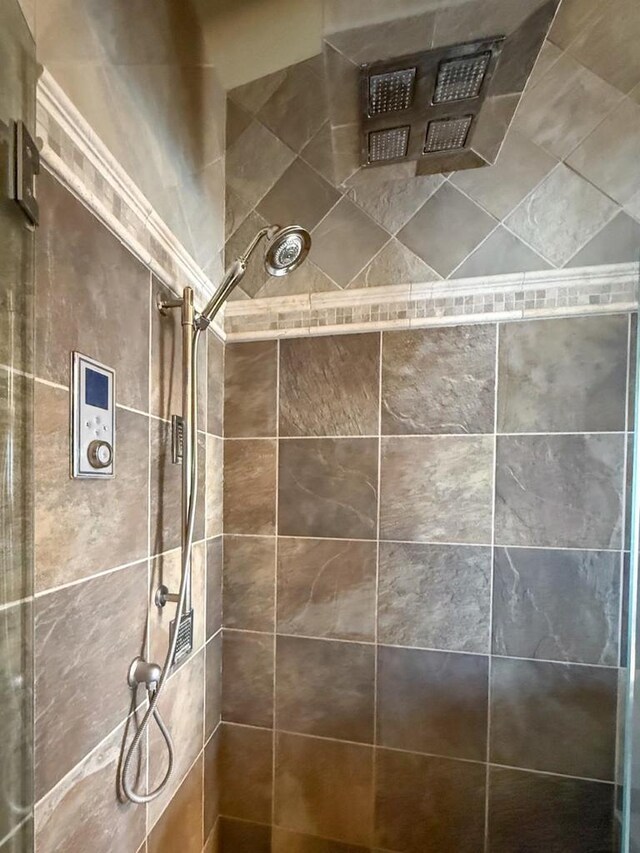 bathroom with tiled shower