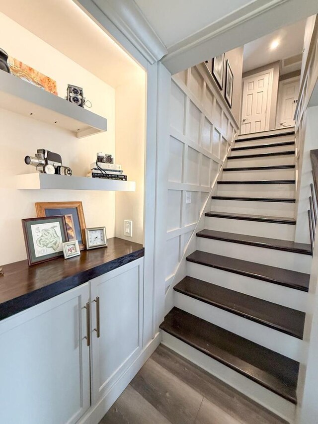 staircase with wood finished floors