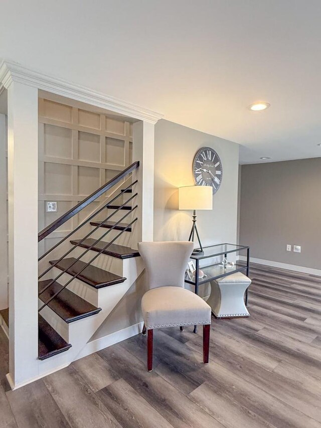 interior space with baseboards, wood finished floors, and recessed lighting