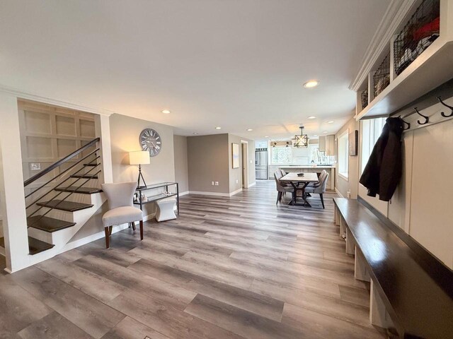 mudroom with baseboards, light wood-style flooring, and recessed lighting