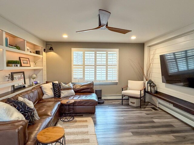 living area featuring a ceiling fan, wood finished floors, recessed lighting, and baseboard heating
