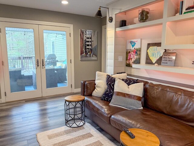 living area with recessed lighting, wood finished floors, and french doors