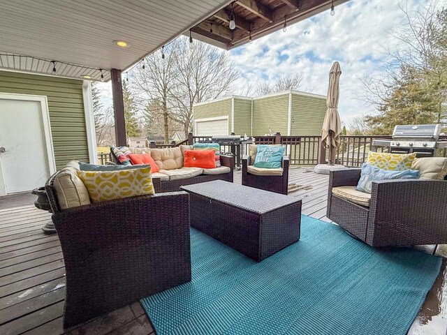 wooden terrace with an outdoor hangout area and area for grilling