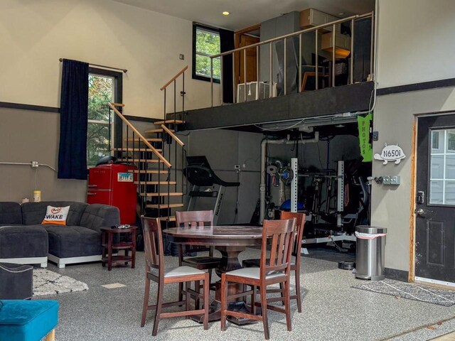 dining room with stairs and a wealth of natural light