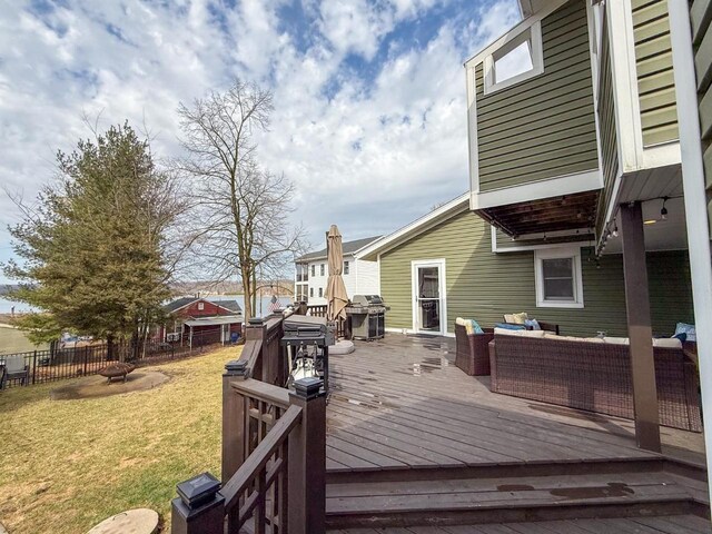 deck featuring a yard, fence, outdoor lounge area, and a grill