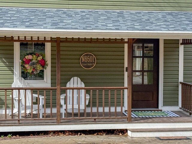 property entrance with a shingled roof
