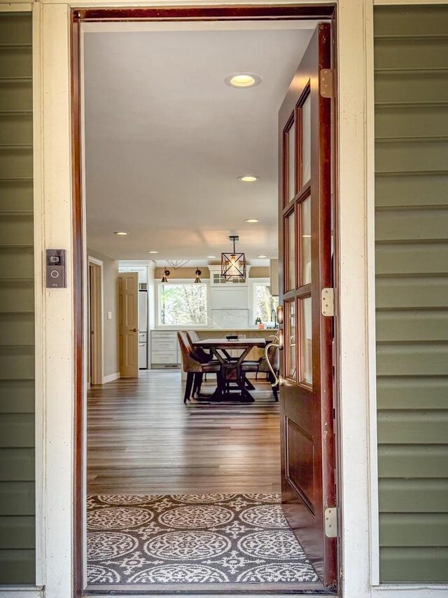 hall with dark wood finished floors and recessed lighting