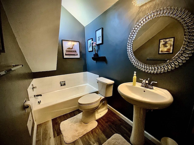 W4862 Swan Acre Dr, Cecil, WI 54111 - full bathroom with toilet, wood finished floors, lofted ceiling, a bath, and baseboards