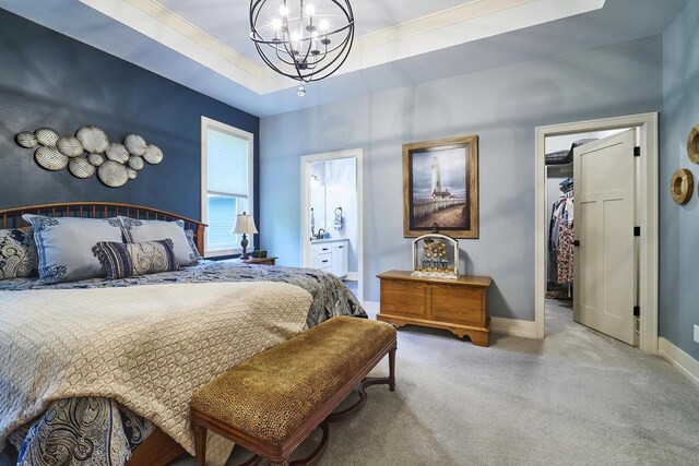 2721 Woodfield Ct, Howard, WI 54313 - bedroom with a raised ceiling, ensuite bath, baseboards, carpet, and an inviting chandelier