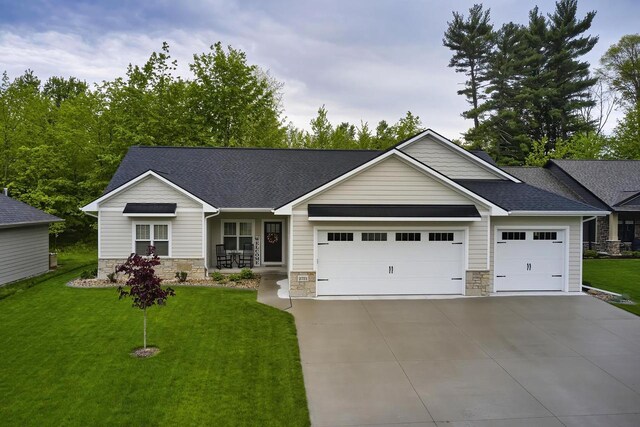 2721 Woodfield Ct, Howard, WI 54313 - single story home with driveway, stone siding, a front yard, and an attached garage