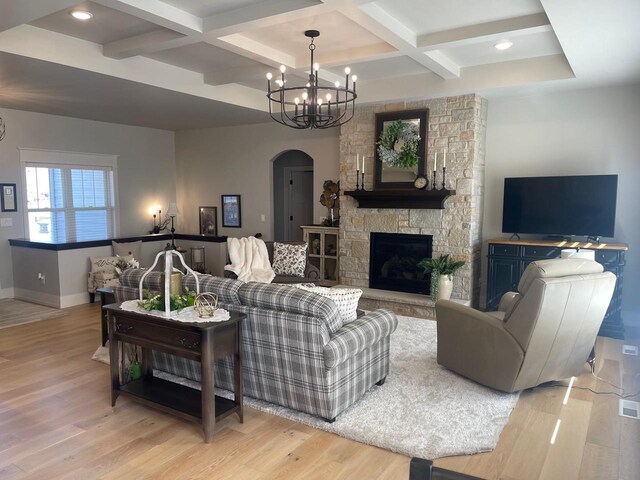 2721 Woodfield Ct, Howard, WI 54313 - living area with baseboards, wood finished floors, arched walkways, an inviting chandelier, and coffered ceiling