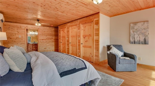 E19535 County Road Nd, Augusta, WI 54722 - bedroom with a wall mounted AC, wooden ceiling, wood finished floors, wood walls, and ensuite bathroom
