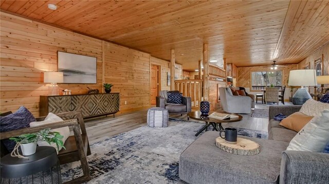 E19535 County Road Nd, Augusta, WI 54722 - living room featuring a ceiling fan, wood finished floors, wooden ceiling, and wood walls