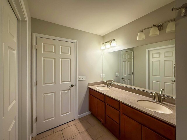2208 W Milwaukee St, Stoughton, WI 53589 - bathroom with double vanity, a sink, and tile patterned flooring