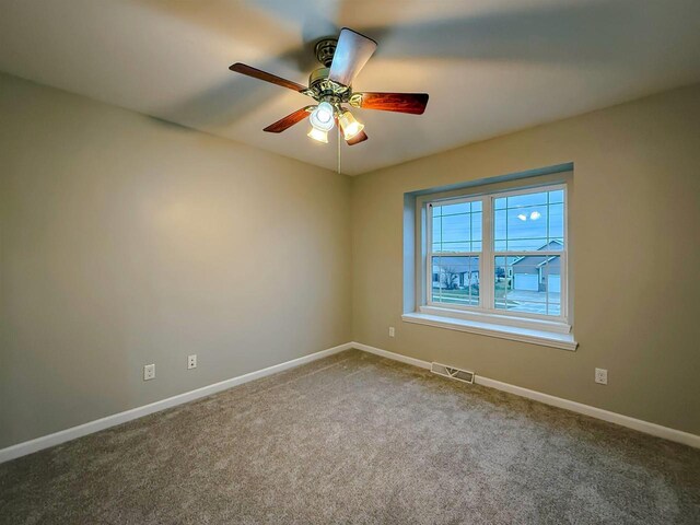 2208 W Milwaukee St, Stoughton, WI 53589 - spare room with carpet flooring, a ceiling fan, baseboards, and visible vents