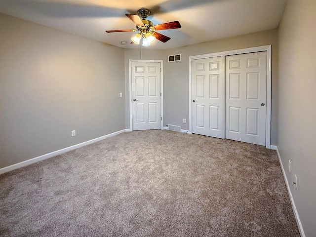 2208 W Milwaukee St, Stoughton, WI 53589 - unfurnished bedroom with a closet, baseboards, visible vents, ceiling fan, and carpet