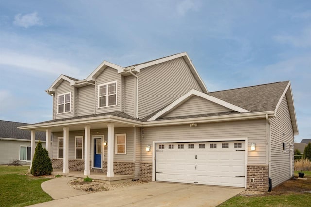 2208 W Milwaukee St, Stoughton, WI 53589 - view of front of home with covered porch, an attached garage, brick siding, driveway, and a shingled roof