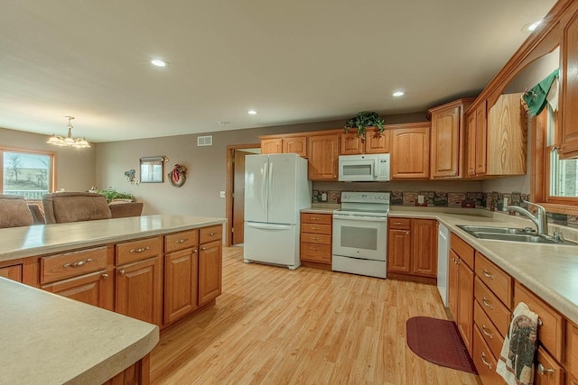 5995 Section Line Rd, Dodgeville, WI 53533 - kitchen featuring light countertops, a sink, white appliances, and a wealth of natural light