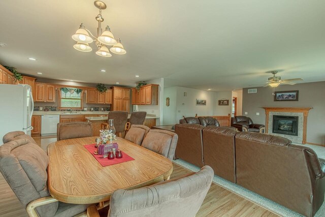 5995 Section Line Rd, Dodgeville, WI 53533 - dining area featuring visible vents, recessed lighting, light wood finished floors, ceiling fan with notable chandelier, and a tile fireplace