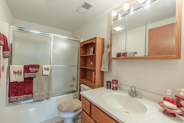 5995 Section Line Rd, Dodgeville, WI 53533 - bathroom featuring toilet, vanity, visible vents, and bath / shower combo with glass door