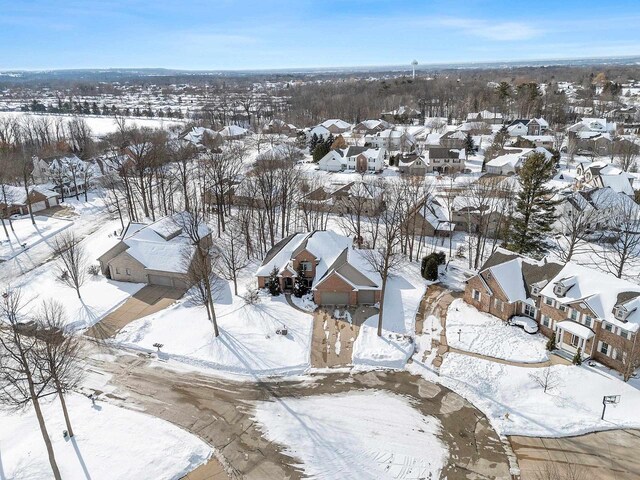 snowy aerial view with a residential view