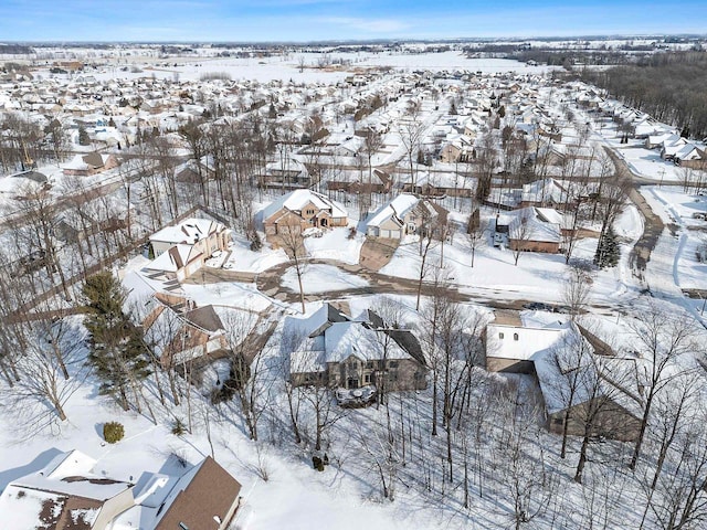 snowy aerial view with a residential view