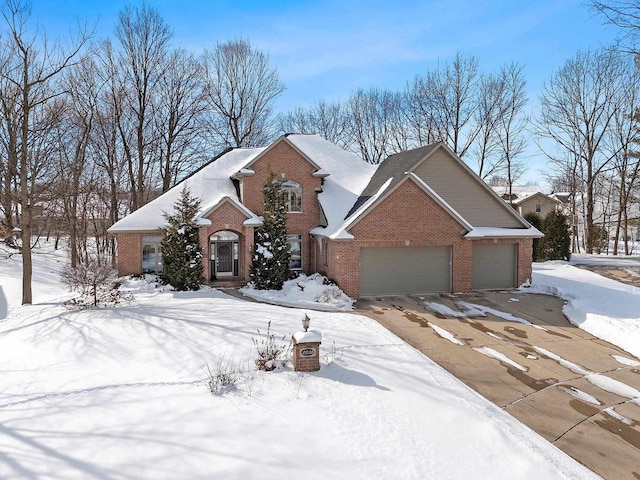 view of front of house featuring a garage, brick siding, and driveway