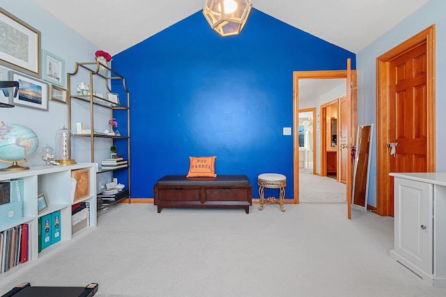 sitting room featuring lofted ceiling, baseboards, and carpet floors