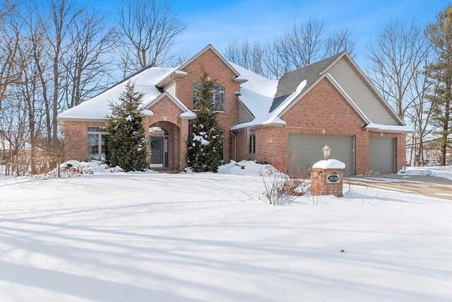 view of front facade featuring an attached garage and brick siding