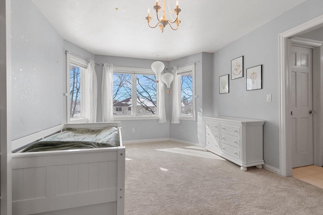 unfurnished bedroom featuring carpet, baseboards, and an inviting chandelier
