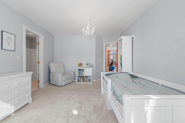 bedroom with a notable chandelier, light colored carpet, and baseboards