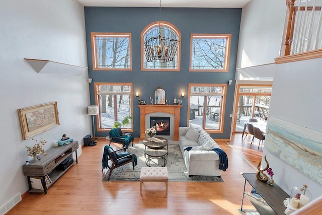 living area featuring visible vents, a wealth of natural light, and wood-type flooring