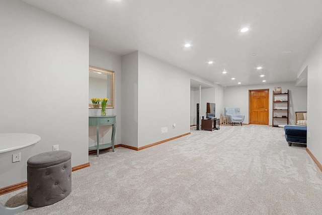 sitting room with baseboards, recessed lighting, and carpet