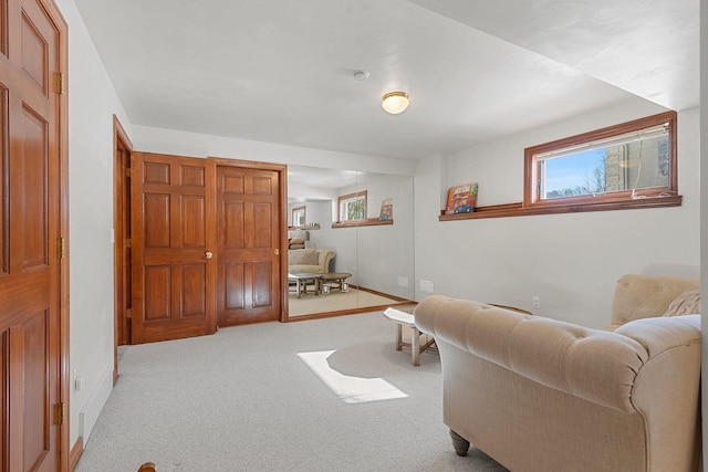 carpeted living room with a wealth of natural light and baseboards