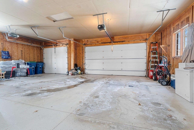 garage with a garage door opener and fridge