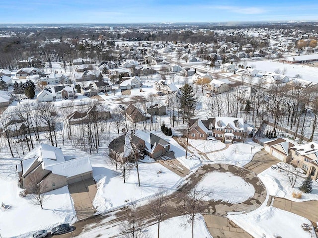 snowy aerial view featuring a residential view