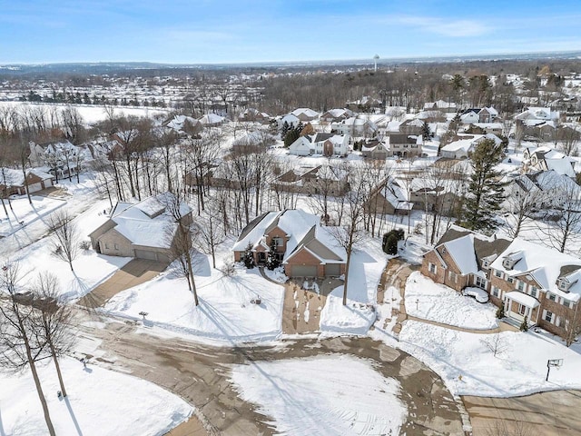 snowy aerial view with a residential view