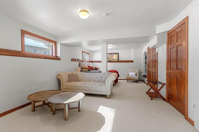 living room featuring light carpet, visible vents, and baseboards