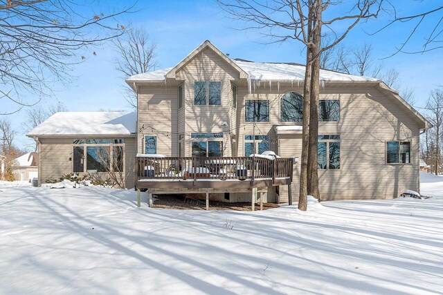 snow covered property featuring a wooden deck