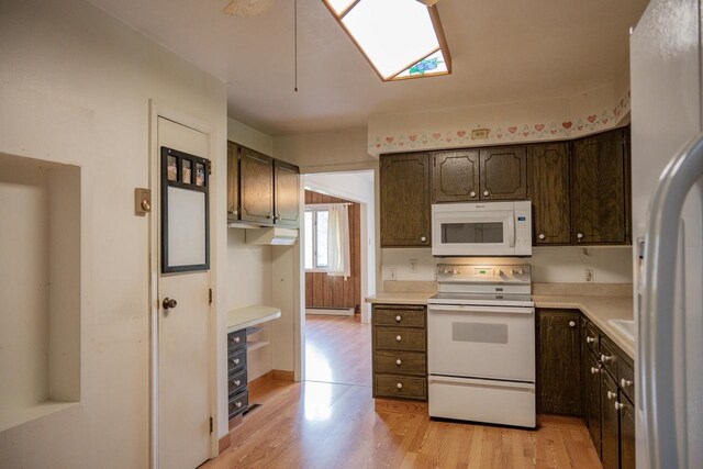 1930 Czech Ave, Arkdale, WI 54613 - kitchen featuring dark brown cabinetry, light countertops, light wood-style floors, and white appliances